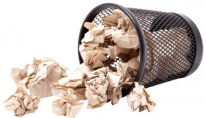 Waste paper spilling out of bin