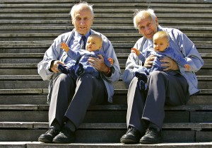 Alf Fehnhann (L) and 79-year-old twin brother Sven hold seven-month-old Luis Carl Millgramm (2nd L) ..